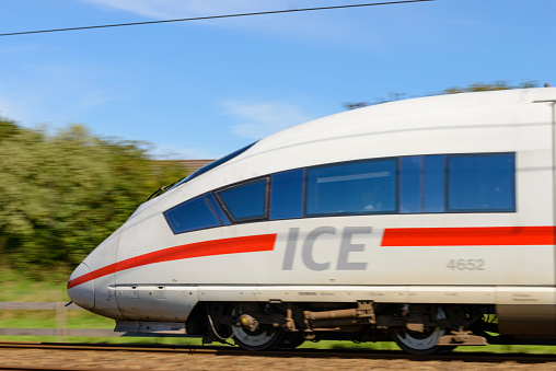 Zevenaar, The Netherlands - September 10, 2015: Approaching German high speed ICE train on the Amsterdam-Cologne line. The Intercity-Express, InterCityExpress or ICE is a system of high-speed trains running in Germany and its surrounding countries. This specific train is an ICE of the third generation, its maximum speed is around 320km/h and runs for both the Dutch Railways (NS) and the Deutsche Bahn (DB).