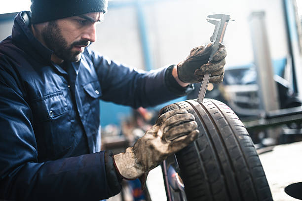istock car tire repairmen with caliber 506868752