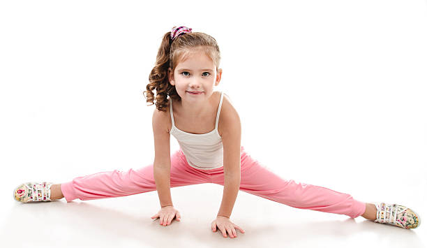 istock Cute little girl doing gymnastic exercise 506870412