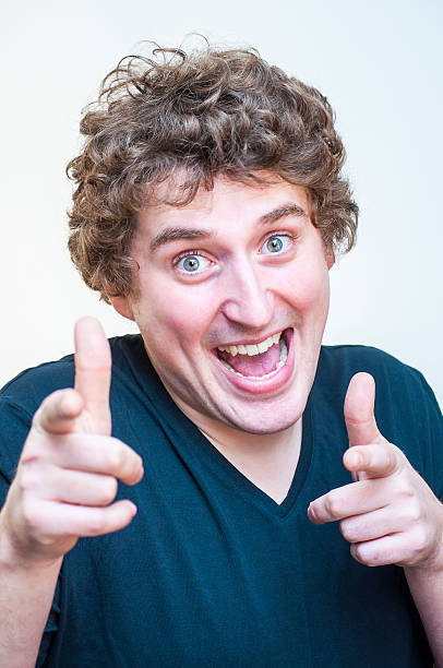 istock Funny, venturesome, curly man pointing fingers on camera 506875178