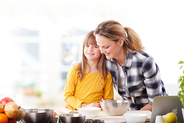 istock Mother and daugther baking together 506875318