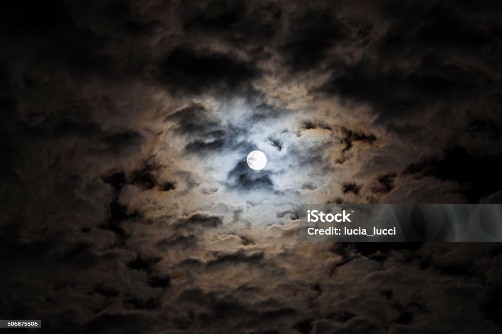 Moon shining in the clouds Bright moon in the clouds Adventure Stock Photo