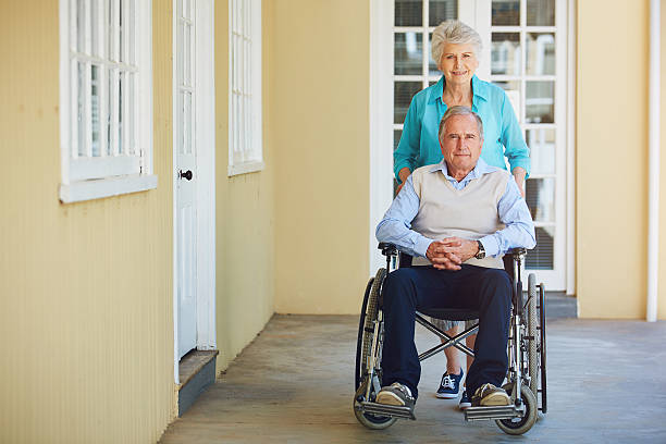 Portrait of a senior woman pushing her husband in a wheelchair at a retirement homehttp://195.154.178.81/DATA/i_collage/pu/shoots/806255.jpg