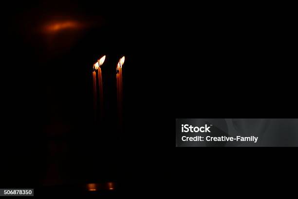 Two Candles Burning In The Dark Stock Photo - Download Image Now - Black Background, Black Color, Burning