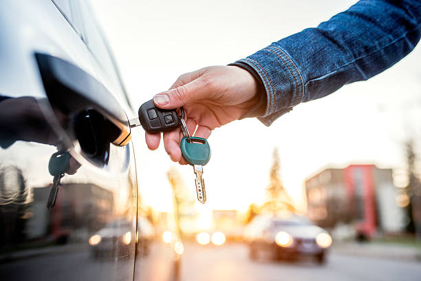 Woman with car key Unrecognizable woman opening her car with a key car key photos stock pictures, royalty-free photos & images