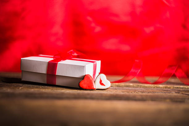 istock White gift box with red hearts and ribbon 506880592
