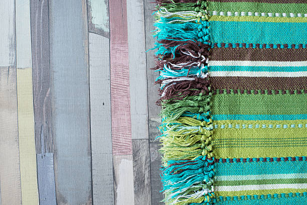 istock Green striped tablecloth on the wooden table. 506882100