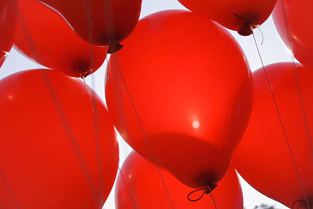 istock Red balloons backlight with early morning sun light. 506883642