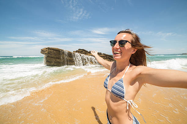 istock Woman arms outstretched on beach 506884188