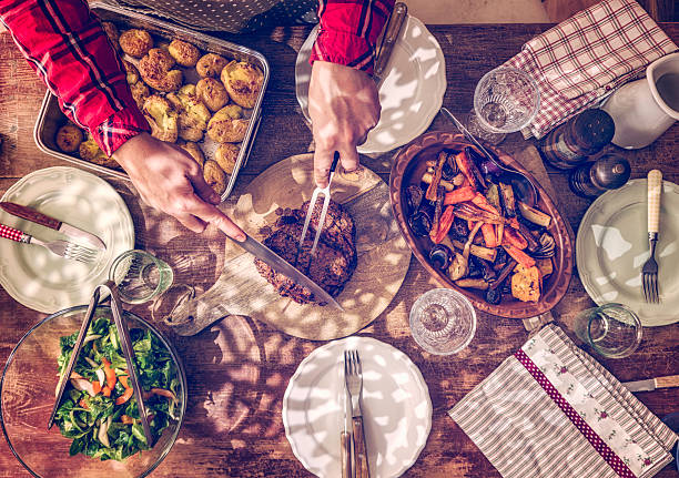istock Carving Roast Beef with Potatoes and Root Vegetables 506884968