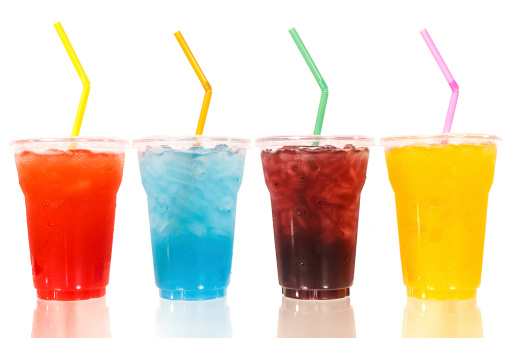 Multi-color cool soft drink with straw on isolated white background