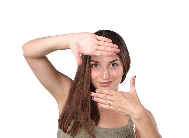 istock Young attractive woman framing her hands 506887227