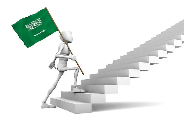 Guy freely walking the stairs to the top and carries the Saudi Arabia flag