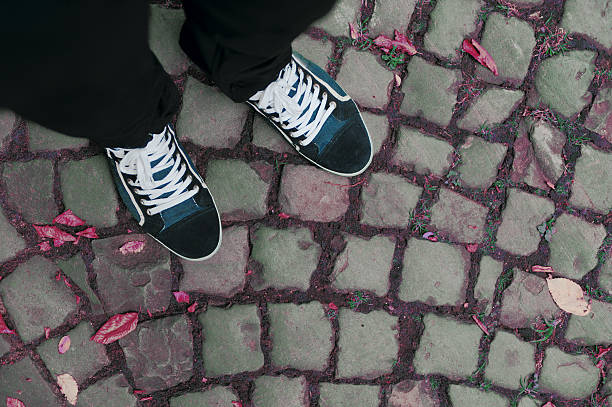 istock Feet on vintage paving stone 506889211