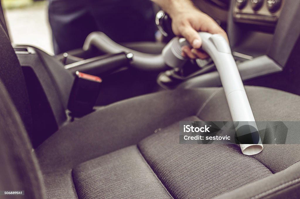 Car vacuuming Cleaning interior of the car using vacuum cleaner Car Stock Photo