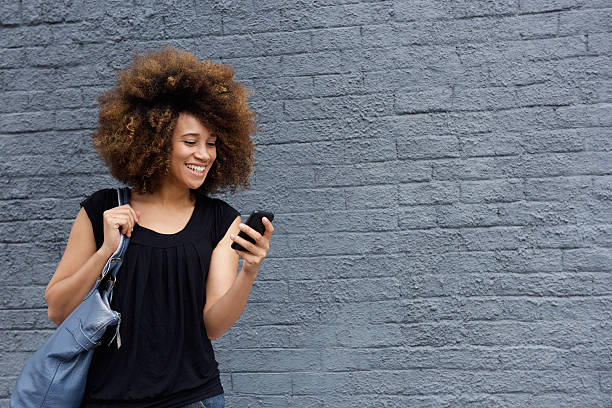 istock Smiling woman with cell phone 506889560