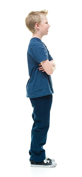 istock Smiling little boy standing with arms crossed 506889658
