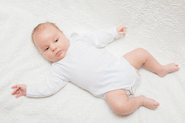 istock Newborn baby in white romper 506890476