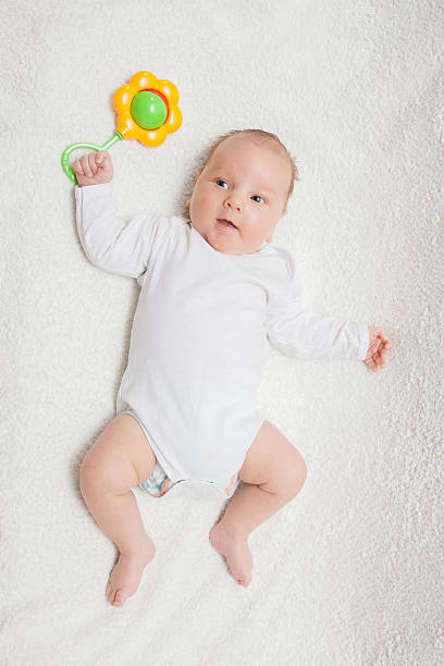istock Newborn baby in white romper 506890512