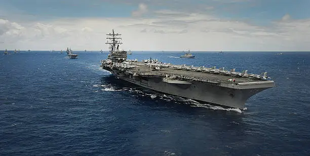 The USS Ronald Reagan (CVN 76) steams in close formation as one of 42 ships and submarines representing 15 international partner nations during Rim of the Pacific (RIMPAC) Exercise 2014. Twenty-two nations, more than 40 ships and six submarines, more than 200 aircraft and 25,000 personnel are participating in RIMPAC exercise from June 26 to Aug. 1, in and around the Hawaiian Islands and Southern California. The world's largest international maritime exercise, RIMPAC provides a unique training opportunity that helps participants foster and sustain the cooperative relationships that are critical to ensuring the safety of sea lanes and security on the world's oceans. RIMPAC 2014 is the 24th exercise in the series that began in 1971.