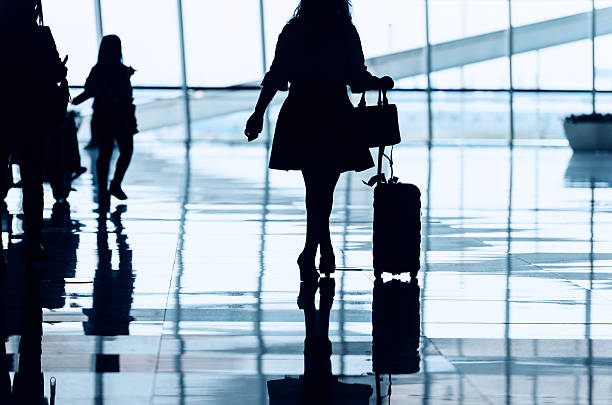 istock travellers walking in modern airport hallway 506892134