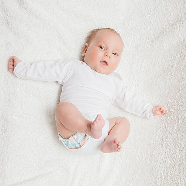 istock Newborn baby in white romper 506897328
