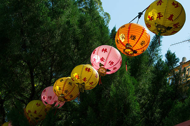 istock Line many-coloured chinese paper lanterns against tree 506897726