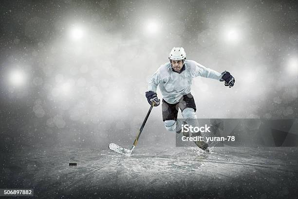 Ice Hockey Player On The Ice Outdoors Stock Photo - Download Image Now - Hockey, Ice Hockey, Hockey Puck