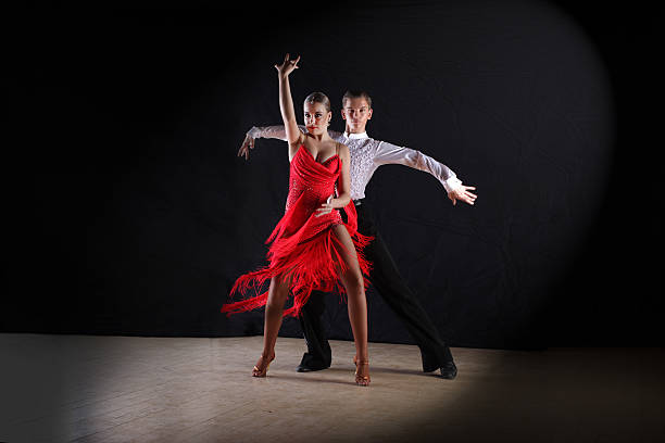 istock Latino dancers in ballroom isolated on black 506898202