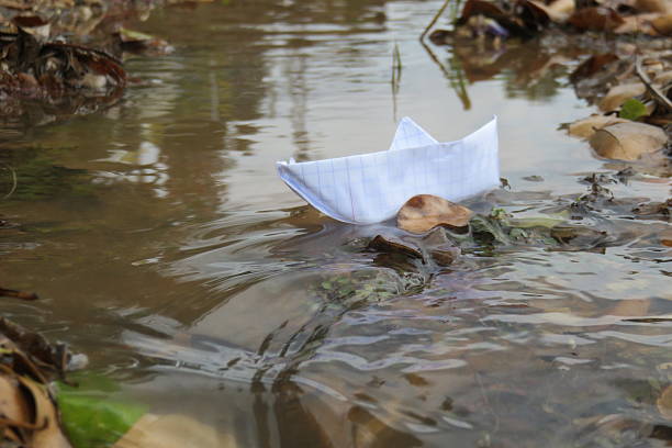istock Paper Boat in rough water 506900292