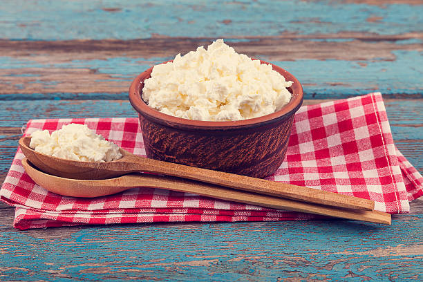 istock Fresh cottage cheese in a ceramic dish and spoon 506900568