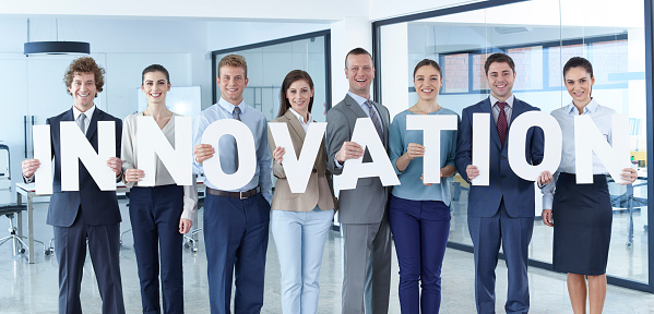 Business team standing in office and holding letters