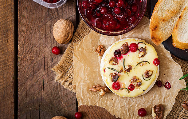 istock Baked cheese Camembert with cranberries and nuts. Top view 506902318
