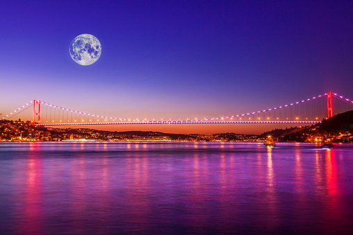 Moon and Istanbul Bosphorus Bridge in the night (digital composite)