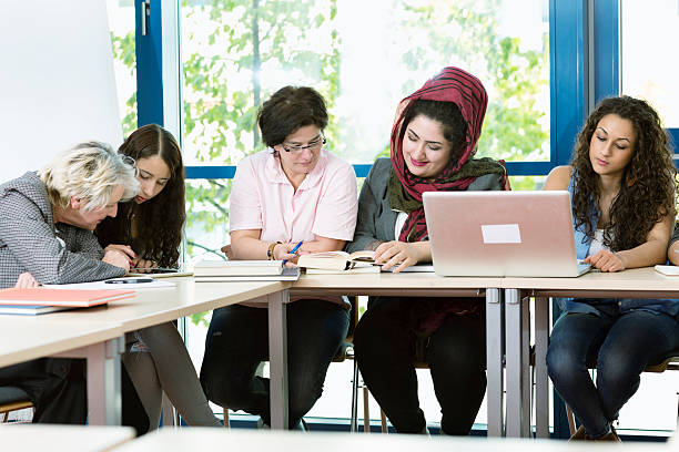 istock students and teacher  in classroom working with digital tablet 506902944