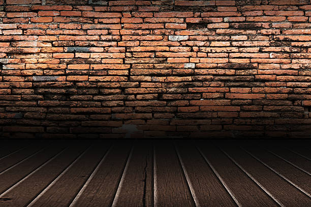 istock old brick wall and brown wooden floor 506903540