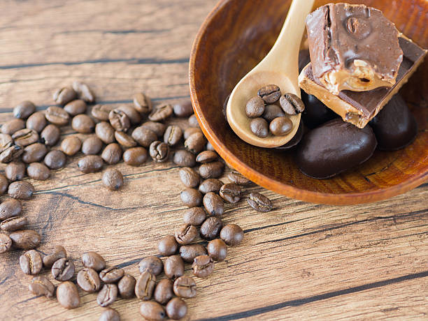 istock Coffee beans arranged heart figure with spoon and chocolate bars. 506903668