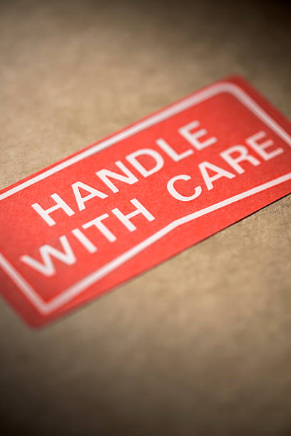 istock Handle with care label on a brown cardboard box 506904802