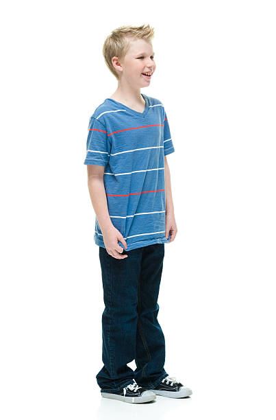istock Smiling little boy standing and looking away 506905312