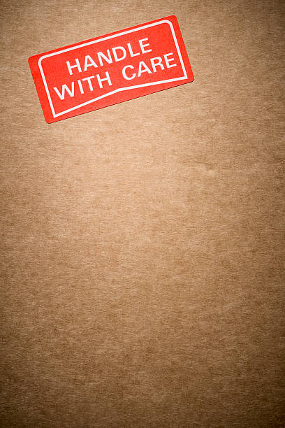istock Handle with care label on a brown cardboard box 506905400