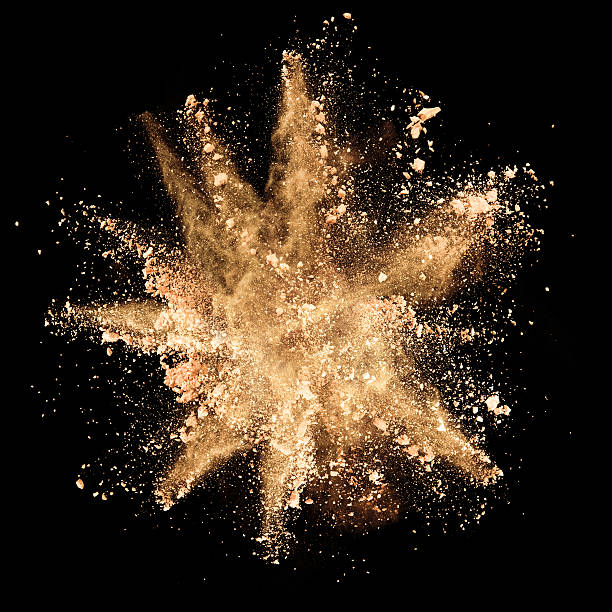 istock Explosion of brown powder on black background 506906580