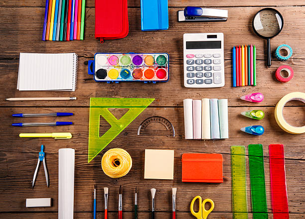 Back to school composition Desk with stationary. Studio shot on wooden background. stapled paper stock pictures, royalty-free photos & images