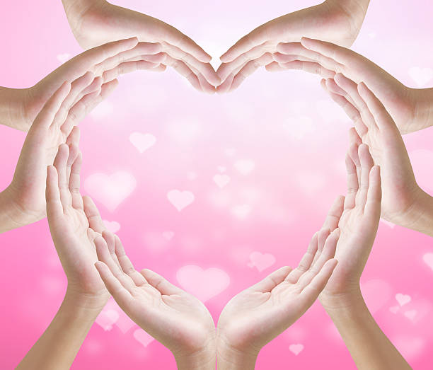 istock Hands make heart shape on  heart bokeh pink background 506909010