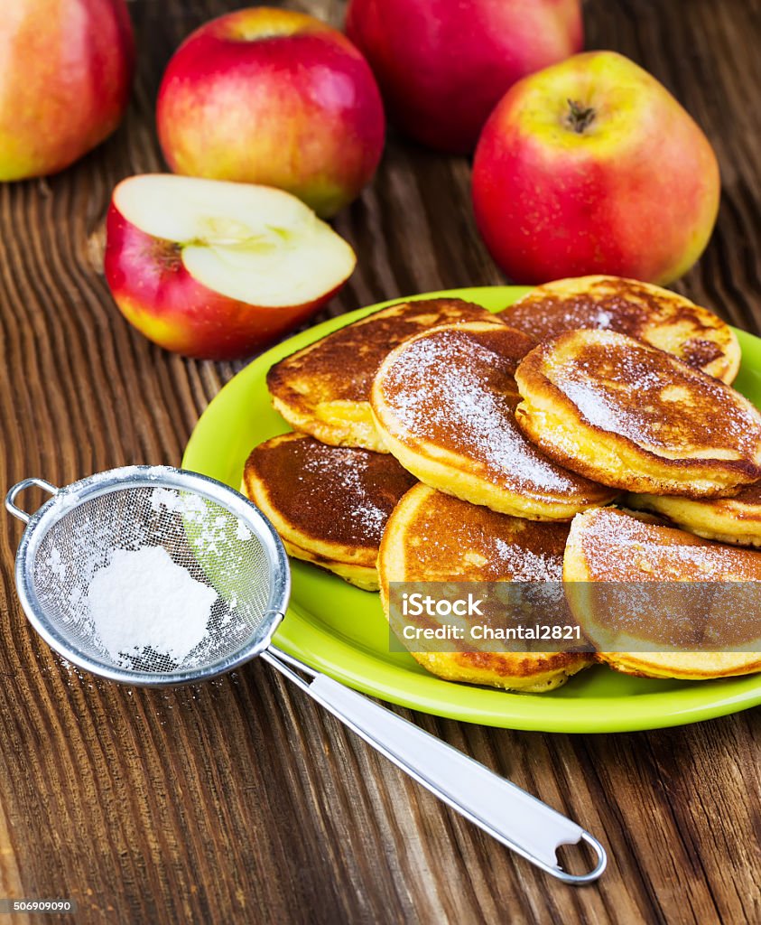 pancakes with apples on a green plate pancakes with apples on a green plate on a wooden background Apple - Fruit Stock Photo