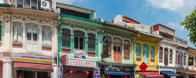 The colourful facades of traditional shophouses with wooden shutters in central Singapore. ProPhoto RGB profile for maximum color fidelity and gamut.