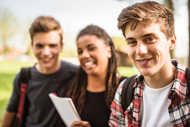 istock group of teenagers student outdoors laughing 506909395