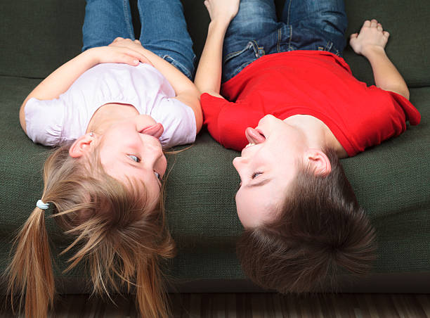 istock Siblings sticking out tongues 506910000