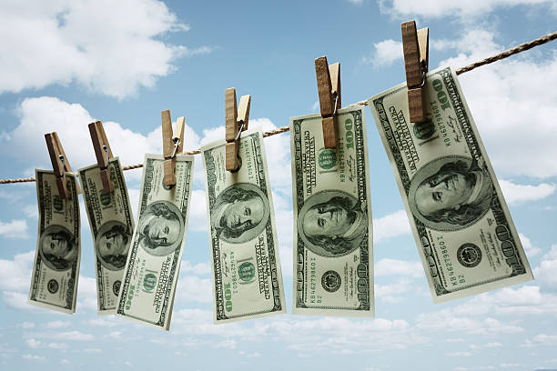 Money laundering Hundred dollar bills hanging from a clothesline concept for money laundering, investment or venture capital funding money laundering stock pictures, royalty-free photos & images