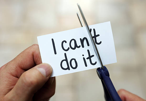 I can do it Man using scissors to remove the word can't to read I can do it concept for self belief, positive attitude and  motivation hope stock pictures, royalty-free photos & images