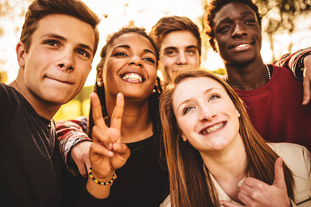 istock Group of college student laughing and doing a selfie 506910919